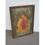 An oak framed and glazed Nestle's Condensed Milk pictorial showcard 'The Richest in Cream' depicting