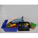 A box full of Duplo bricks, airliner and others.