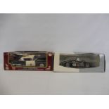 Two 1:18 scale boxed models, one being an American Police Chief Eldorado, the other an Audio R8R