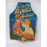 A Bird's Custard apron brightly decorated with a boy and girl, probably 1970s.