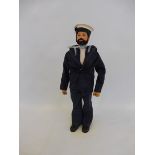 A 1970s Action Man with beard and black flock hair, in a British sailor's outfit.