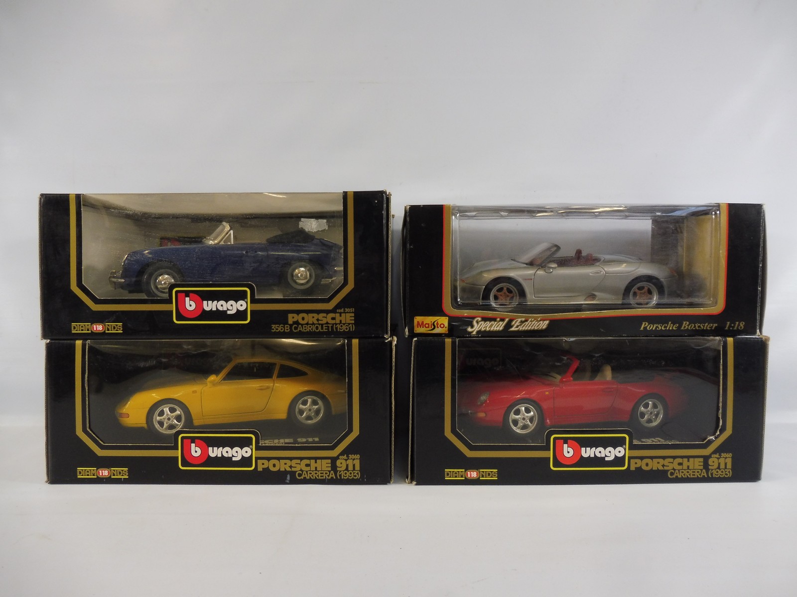 Four boxed Burago 1:18th scale, all Porsche cars, boxes good.