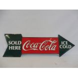 A Coca-Cola tin directional arrow dated 1990, 27 x 9".