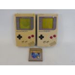 Two Nintendo Gameboys, unchecked condition, one with a game.