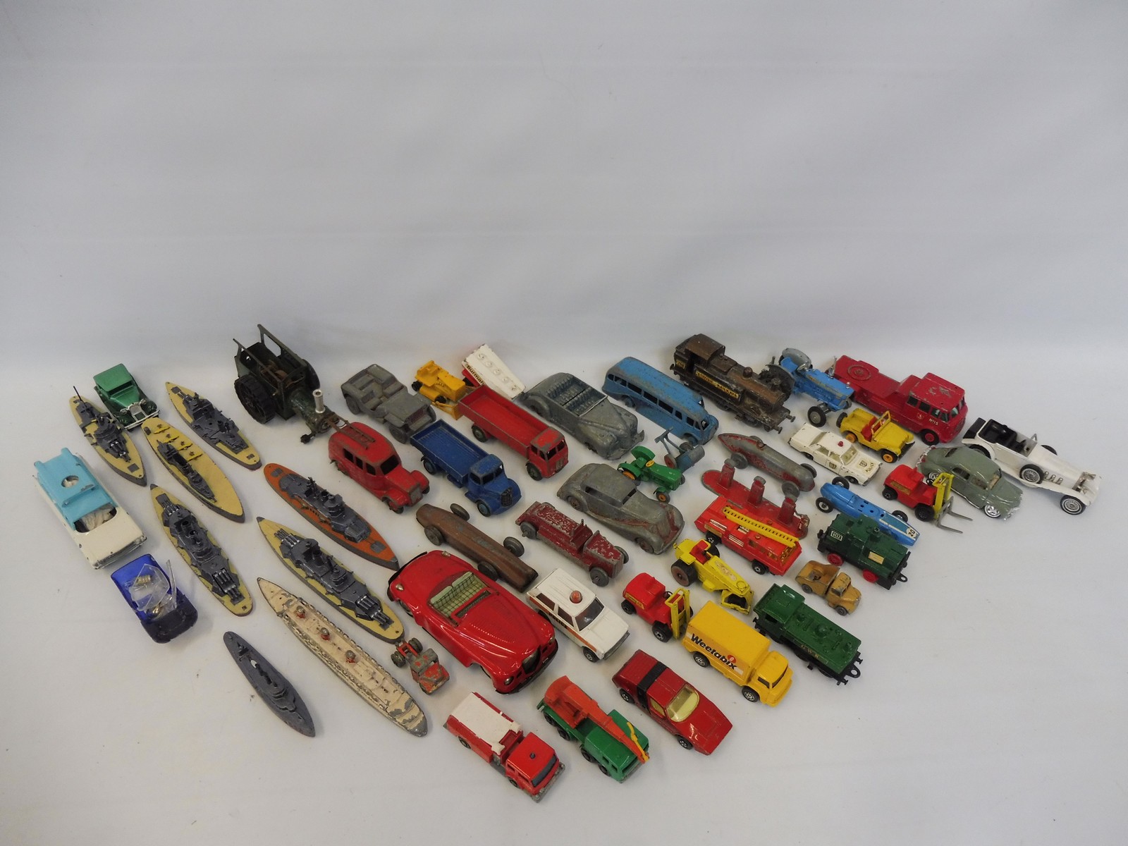 A box of assorted playworn die-cast models to include early Dinky, also an amount of repainted