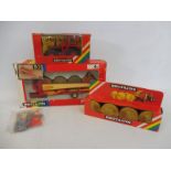 A boxed Britains rainbow box farm tractor Volvo BN and a round bale wagon and a 1743 round hay bales