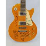 A multi signed Made in the USA guitar, bearing the name Gibson, signed by Paul Carrack