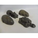 Four early lead doorstops, each moulded as a different animal including a tortoise and a rabbit.