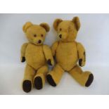 Two straw filled teddy bears with glass eyes.