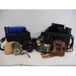 A collection of cameras, lenses and accesories including Canon.