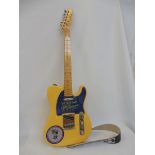 A guitar bearing the name Fender Telecaster, serial number E329385, bearing the
