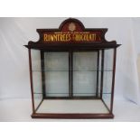 A large counter top rear opening display cabinet with Rowntree's Chocolates glass pediment, 31" wide