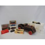 A small quantity of boxed die-cast models, a wooden push along folk art train etc.