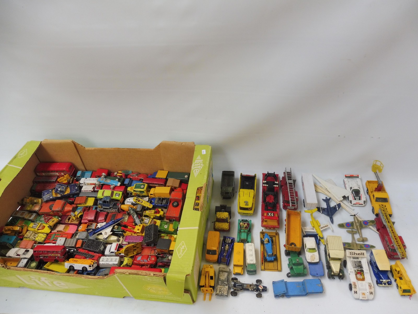 A large box of playworn die-cast vehicles, differing eras and makes.