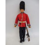 Original Action Man - a circa 1970s flock haired figure, wearing a grenedier guards uniform plus