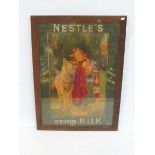 An oak framed and glazed Nestle's Condensed Milk pictorial showcard 'The Richest in Cream' depicting