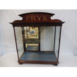A Fry's Chocolates mahogany and glass counter top dispensing cabinet with sliding mirrored rear