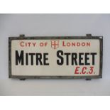A City of London 'Mitre Street E.C.3.' milk glass sign set within an aluminium frame, 27 x 13 1/2".