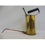 An Optimus of Sweden polished brass hand held oiler with copper spout.