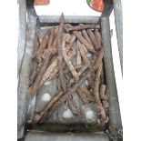 A quantity of circa 1930s handmade tent pegs from a fairground, in a contemporary aluminium crate.