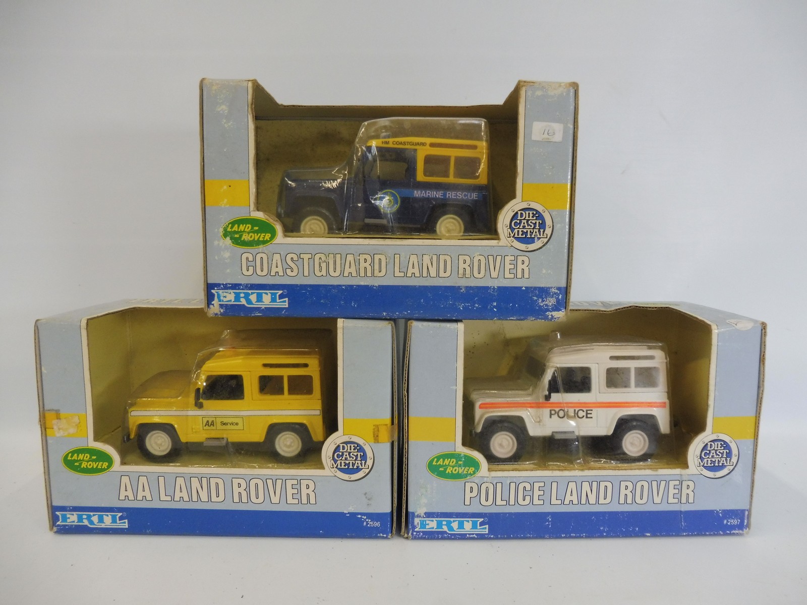 Three boxed Ertl 1:32 scale Land Rovers.