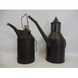 Two large early oil cans.