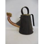 A ribbed steel hand held lamp with copper spout containing a wick, possibly railway.