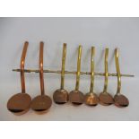 Seven copper and brass measures.