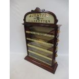 A Muratti's High Class Cigarettes mahogany and glass fronted five drawer dispensing cabinet with