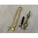 A selection of charms in yellow and white metal including a die plus two watch keys.