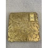 A silver compact case, with chased acanthus decoration and unusually inset with a watch movement