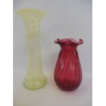 A Victorian yellow vaseline glass vase, 10" h, together with a wrythen cranberry glass vase, 7" h.