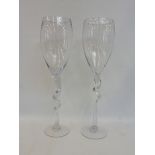 A pair of oversized wine glasses, with twisted stems.