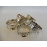 Five sterling silver napkin rings.