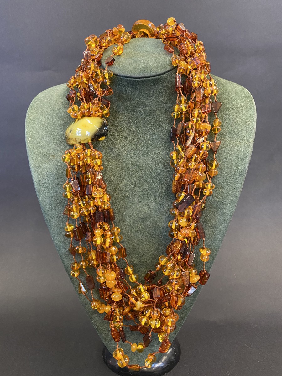 A multi-strand necklace, possibly part amber.