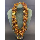 A multi-strand necklace, possibly part amber.