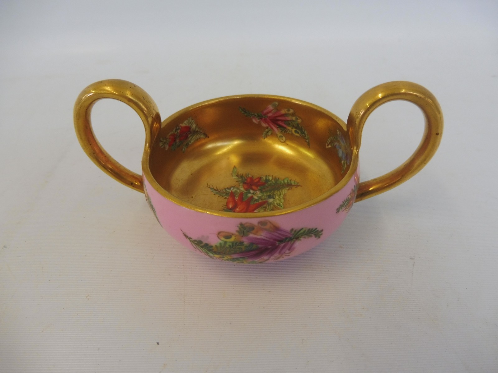 A Coalport porcelain two handled cup with gilded decoration and painted floral sprigs. - Image 2 of 4