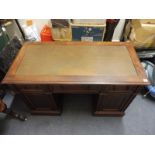 A late 19th Century twin pedestal writing desk in the manner of Gillows.