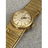 A 9ct gold Omega Ladymatic wristwatch with original strap.