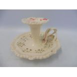 A creamware chamber stick with interwoven handle, impressed CCL to the base.