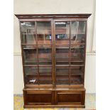 A Georgian mahogany estate bookcase of two glazed doors above a cupboard base, 57" wide x 82 1/2"