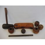 A 19th Century head rest, treen mallet, rule, ball and four lignum horse tethering blocks.