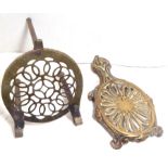 Two brass trivets, one with short legs.