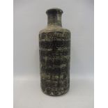 A studio pottery vase with repeating incised decoration, signed to base, 9 1/2" high.