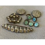A nine stone dress brooch of arched form, two paste buttons, a selection of enamel dress buttons