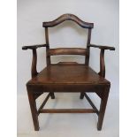 A Georgian Folk Art elm country armchair with make-do repairs.