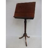 A mahogany reading stand with adjustable top.