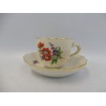 A 19th Century Continental porcelain cup and saucer, in the manner of Meissen, blue crossed swords