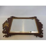 An 18th Century walnut wall mirror with gilt branding and ho-ho bird finial.