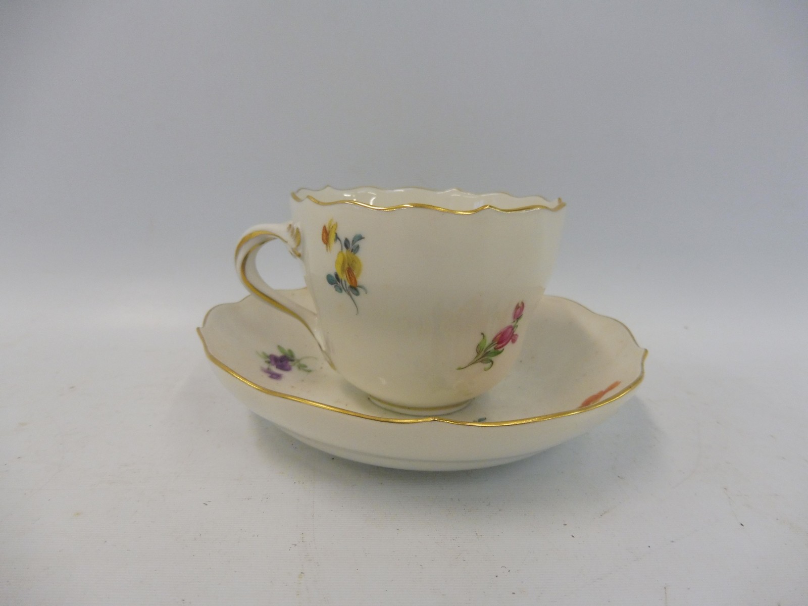 A 19th Century Continental porcelain cup and saucer, in the manner of Meissen, blue crossed swords - Image 2 of 4